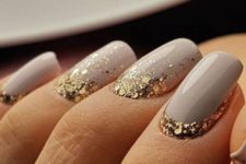 10 dove grey nails with large scale gold glitter at the base