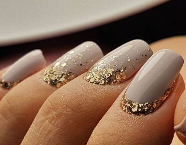 dove grey nails with large scale gold glitter at the base