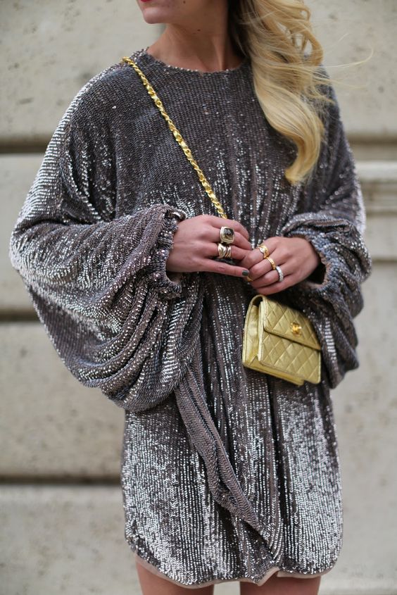 a grey sequin mini dress with wide sleeves, a high neckline and a sash