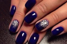 11 electric blue nails with large rhinestones for an accent