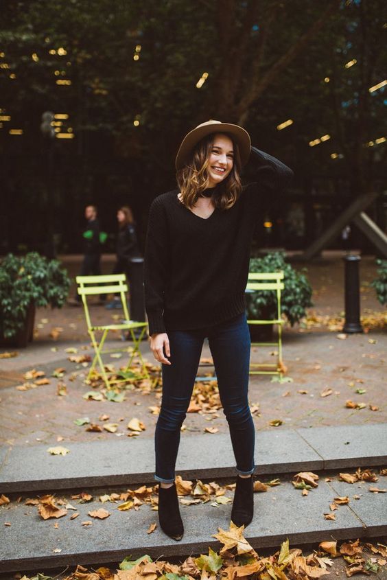 a black chunky kit sweater, navy jeans and black suede boots