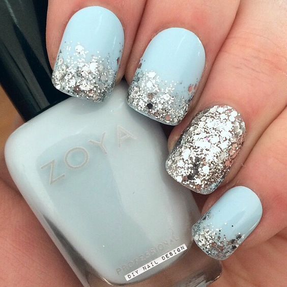 light blue nails with large scale silver glitter