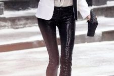 13 a zip shirt, a white and black jacket, black sequin pants and a matching clutch