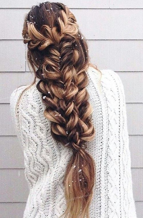 a large voluminous braid made of several braids on long hair looks just jaw-dropping