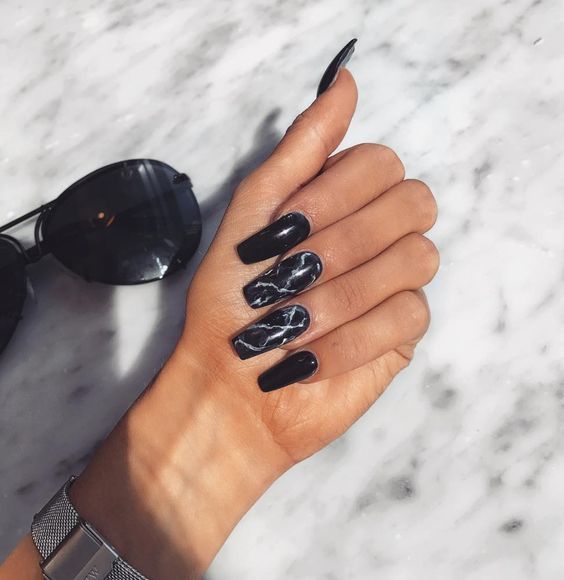 long black nails plus two black marble accent ones are very edgy