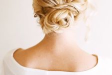 15 a messy, wavy twsited low bun with all hair up