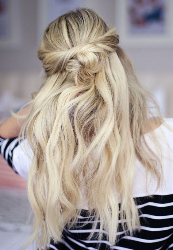 a simple half updo with twists, a bun and wavy hair down for an effortlessly chic look