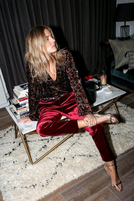 burgundy velvet pants, a vintage-inspired floral blouse and metallic shoes