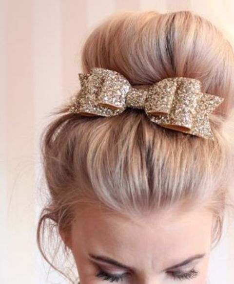a top knot with a glitter bow looks very glam-like and cute