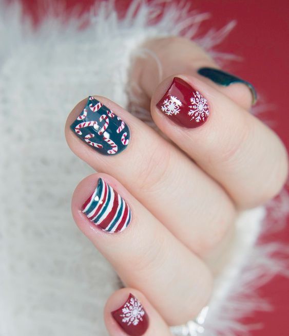 red, dark green and whiet nails with snowflakes, candy canes and stripes