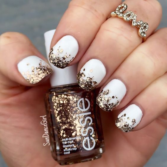 white nails with gold glitter hexagons for a chic glam look