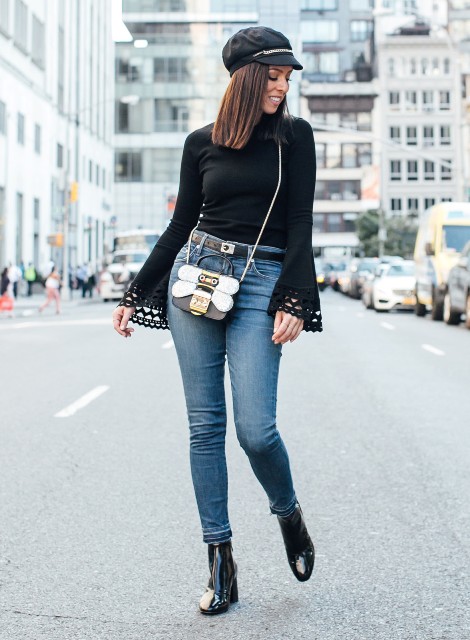 With black blouse, skinny jeans, black boots and unique bag