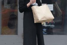 With black coat, dress, gray tights and leather boots