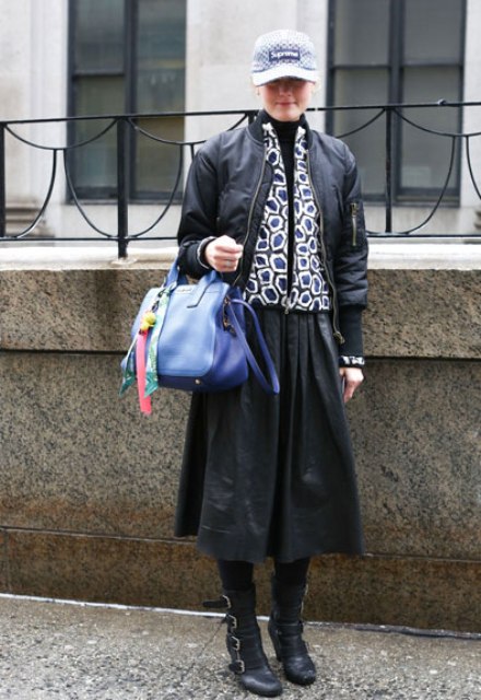 With black jacket, printed jacket, midi skirt, mid calf boots and blue bag