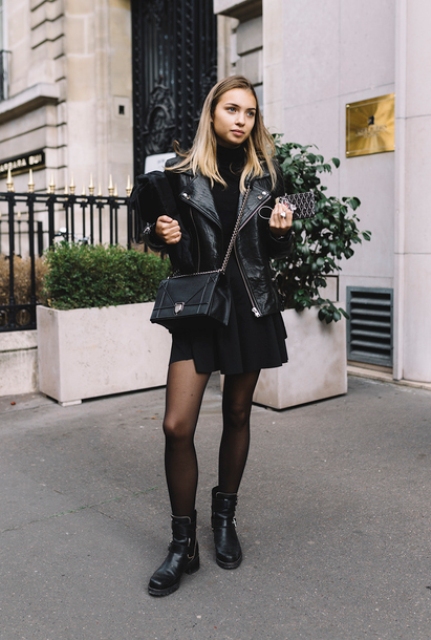 With black leather jacket, chain strap bag, mini dress and black tights
