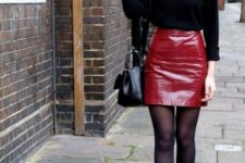 With black shirt, black tights, ankle boots and leather bag