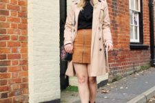 With black shirt, brown skirt, beige coat and black ankle boots