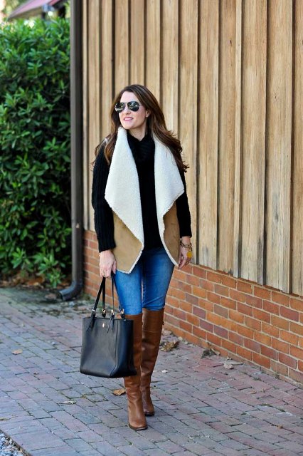 With black sweater, skinny jeans, brown boots and black tote