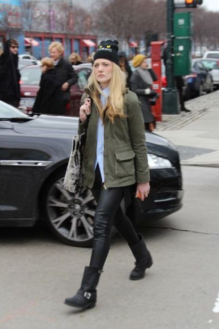 With button down shirt, olive green jacket, beanie and leather pants