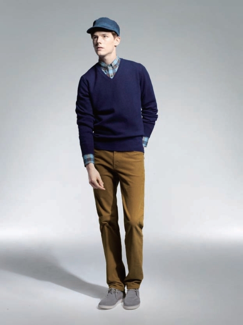 With checked shirt, navy blue sweater, blue cap and brown trousers