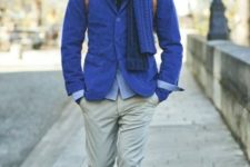 With cobalt blue jacket, scarf, beige pants and shoes