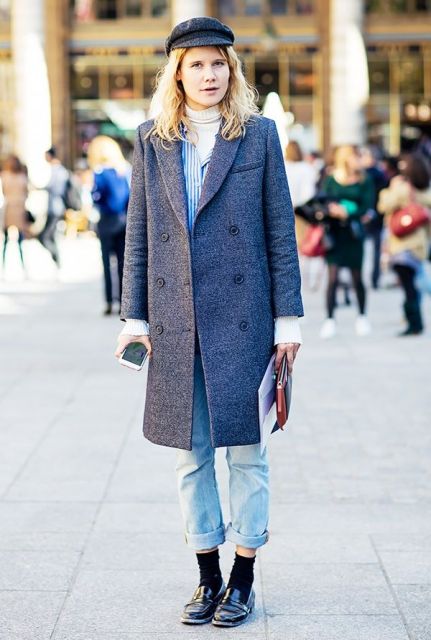 With cuffed jeans, tweed coat, black socks and black shoes