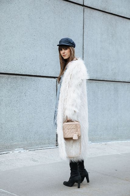 With dress, boots, faux fur coat and beige bag