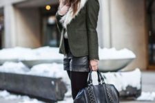 With fur collar green jacket, wide brim hat, embellished ankle boots and leather bag