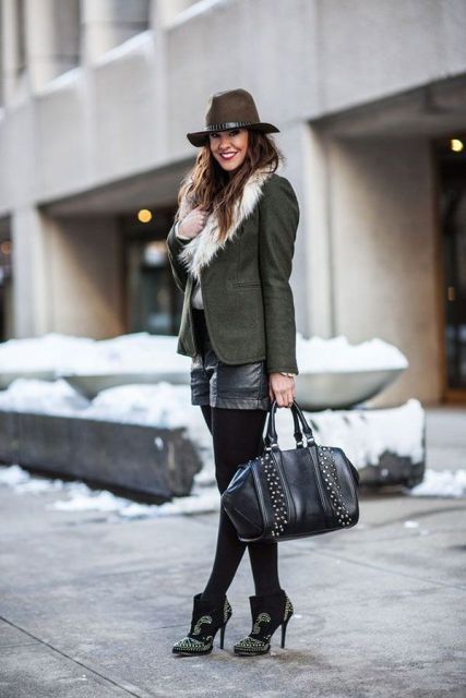 With fur collar green jacket, wide brim hat, embellished ankle boots and leather bag
