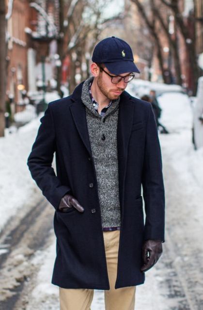 With gray sweater, beige trousers and navy blue coat