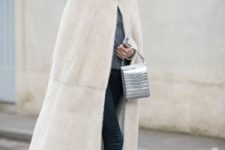 With gray turtleneck sweater, cuffed jeans, black flats and metallic bag