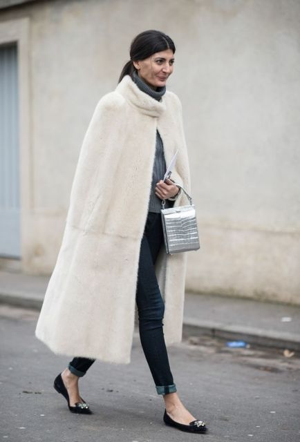With gray turtleneck sweater, cuffed jeans, black flats and metallic bag