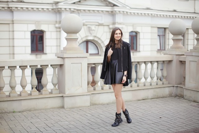With leather skirt, black top and black jacket