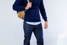 With light blue shirt, navy blue sweater, cuffed jeans and backpack