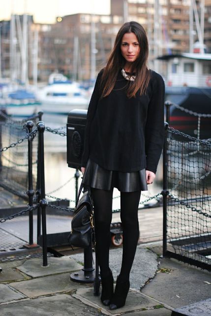 With oversized shirt, ankle boots and black bag