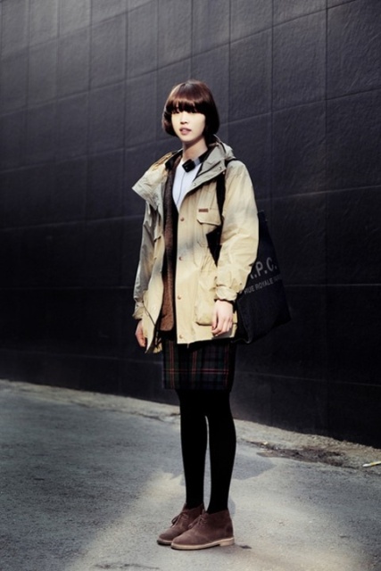 With parka coat, checked skirt, black tights and bag