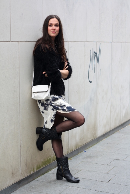 With printed skirt, black sweater and white bag