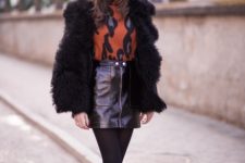 With printed turtleneck, fur coat, black tights and mid calf boots