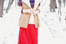 With red maxi skirt, printed sweater and fur hat