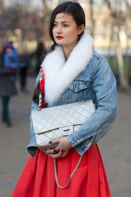 With red skirt and silver bag