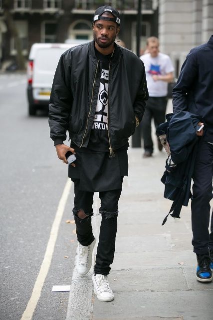 With shirt, distressed pants, white sneakers and black bomber jacket