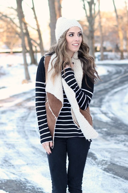 With striped shirt, white beanie and black pants