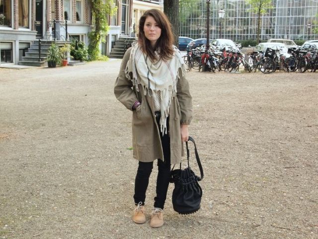With sweater, black pants, knee-length coat and oversized scarf