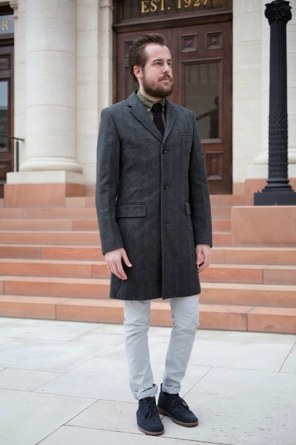 With tweed coat and light gray pants
