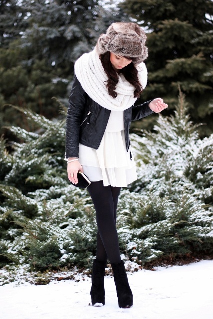 With white dress, black tights, ankle boots, leather jacket and white scarf