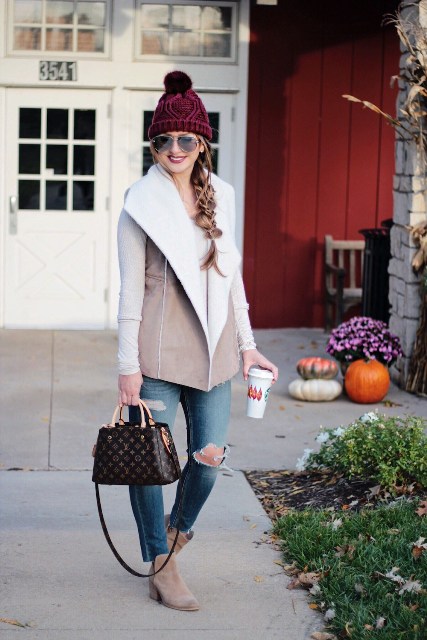 With white shirt, distressed jeans, suede ankle boots, printed bag and marsala beanie