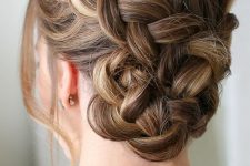 a Dutch braided bun with a bump on top and face-framing hair is a cool and catchy solution to rock