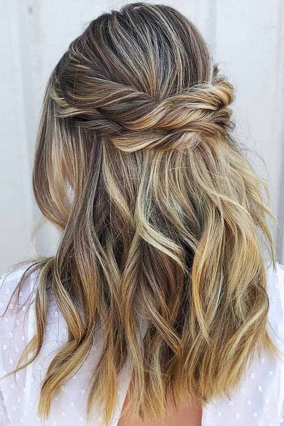 a beautiful and relaxed half updo with a bump on top,a  double twisted halo and waves down is a cool idea