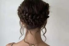 a beautiful and simple braided low updo with a halo and some locks down is a chic and cool idea for a holiday party