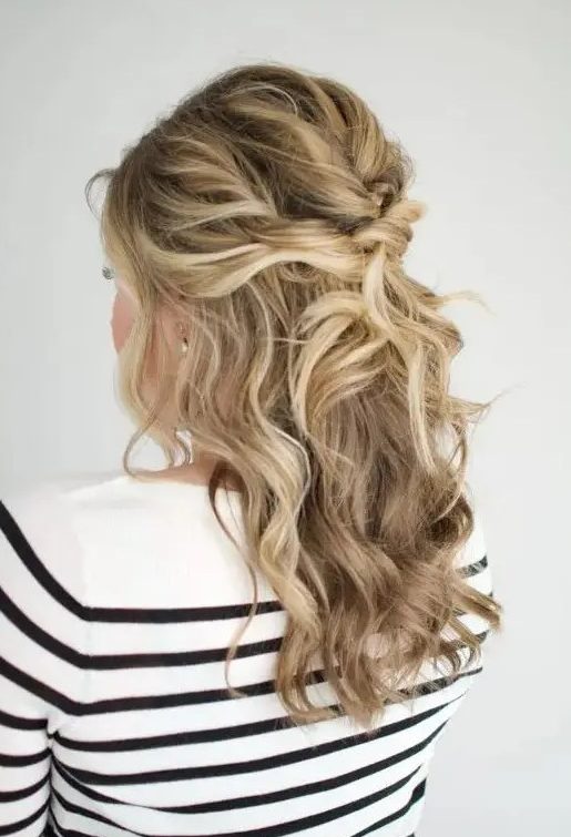 A beautiful messy twisted and wavy half updo with a bump on top and some face framing locks is amazing for a holiday party